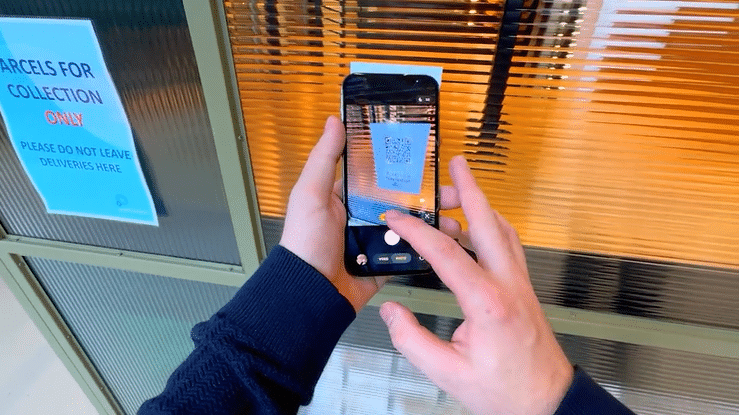 A video showing a person accessing a Zapworks Spaces navigation experience via a QR code. 